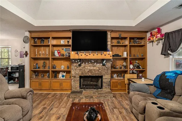 a living room with furniture a flat screen tv and a fireplace