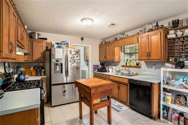 a kitchen with stainless steel appliances granite countertop a stove and a refrigerator