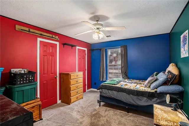 a bedroom with bed and a window