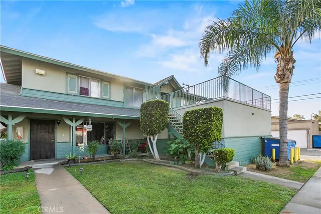 a front view of a house with garden