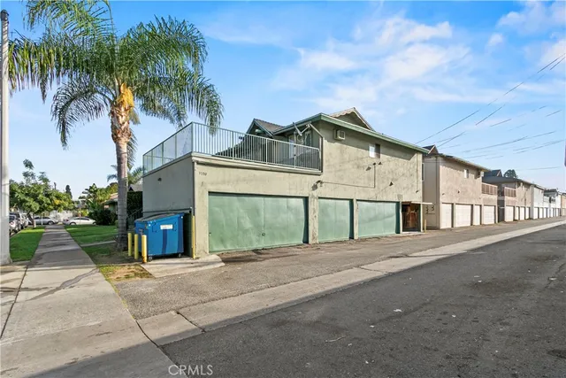 a front view of house with yard and trees around