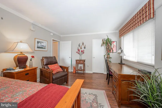 a bedroom with furniture and a wooden floor