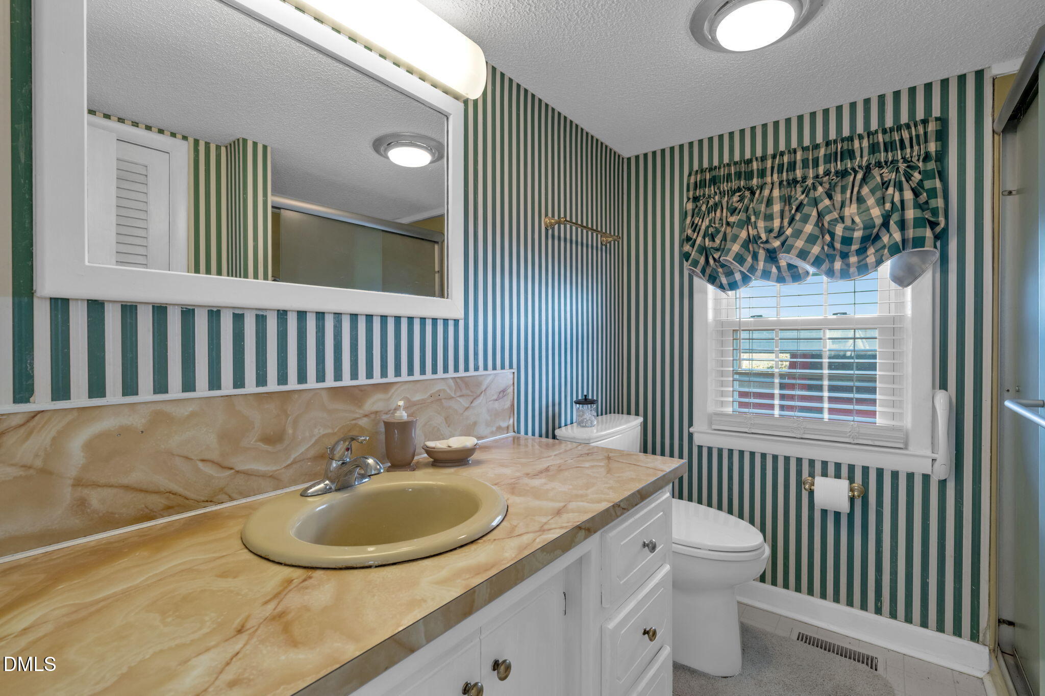 401 Allens Crossroads Road Four Oaks, NC 27524 - Photo 14 of 64 a bathroom with a sink and a mirror