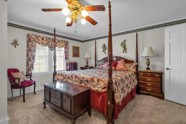 a bedroom with a bed and wooden furniture