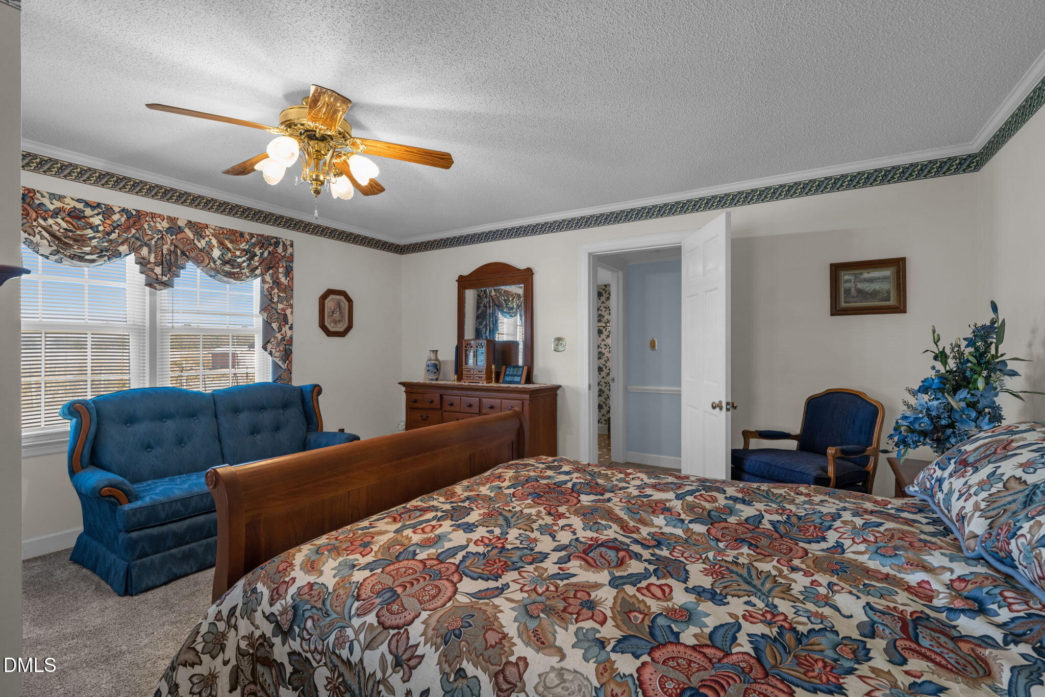 401 Allens Crossroads Road Four Oaks, NC 27524 - Photo 21 of 64 a bedroom with a bed and a chandelier