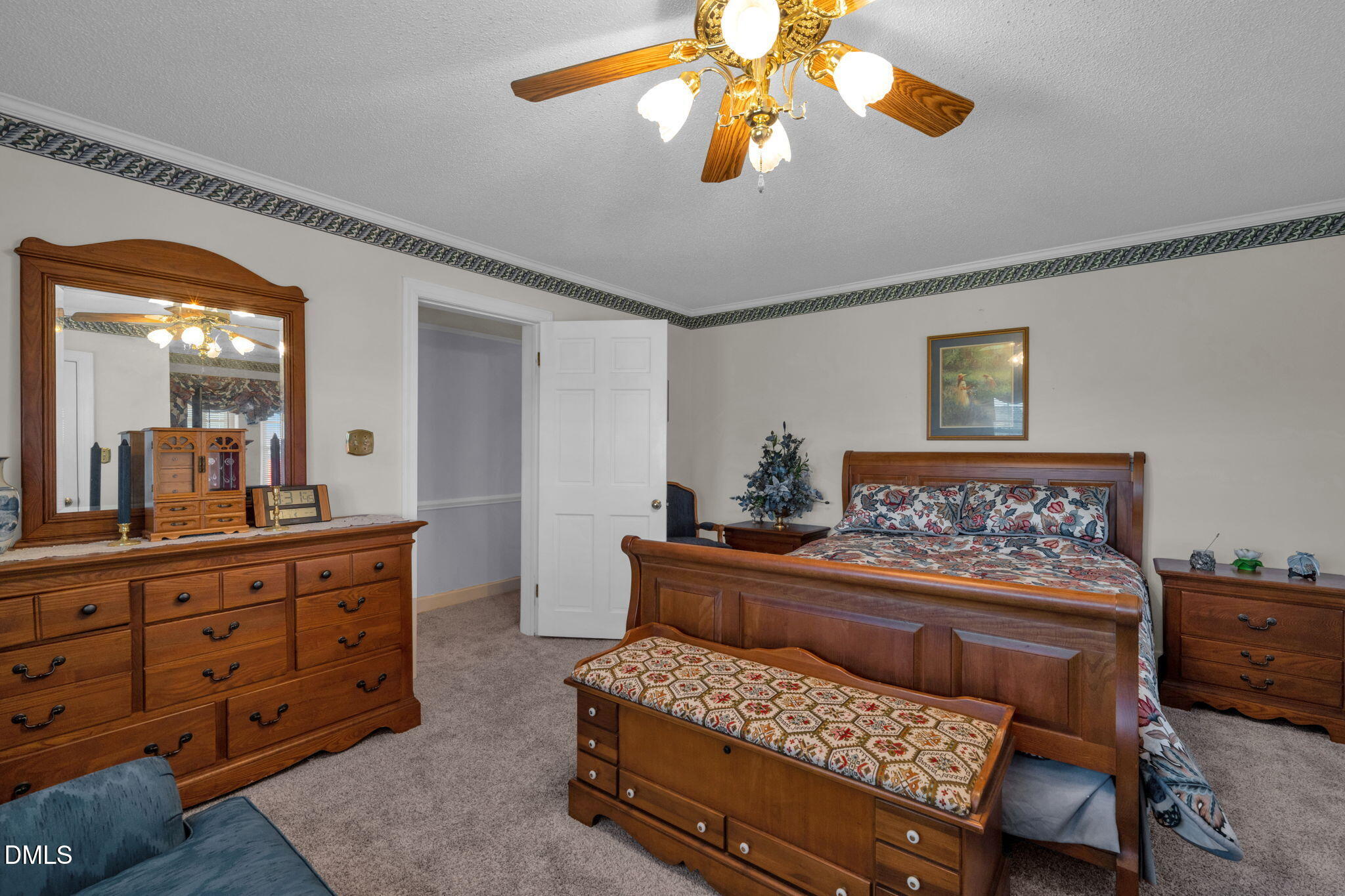 401 Allens Crossroads Road Four Oaks, NC 27524 - Photo 22 of 64 a bedroom with a bed and wooden furniture