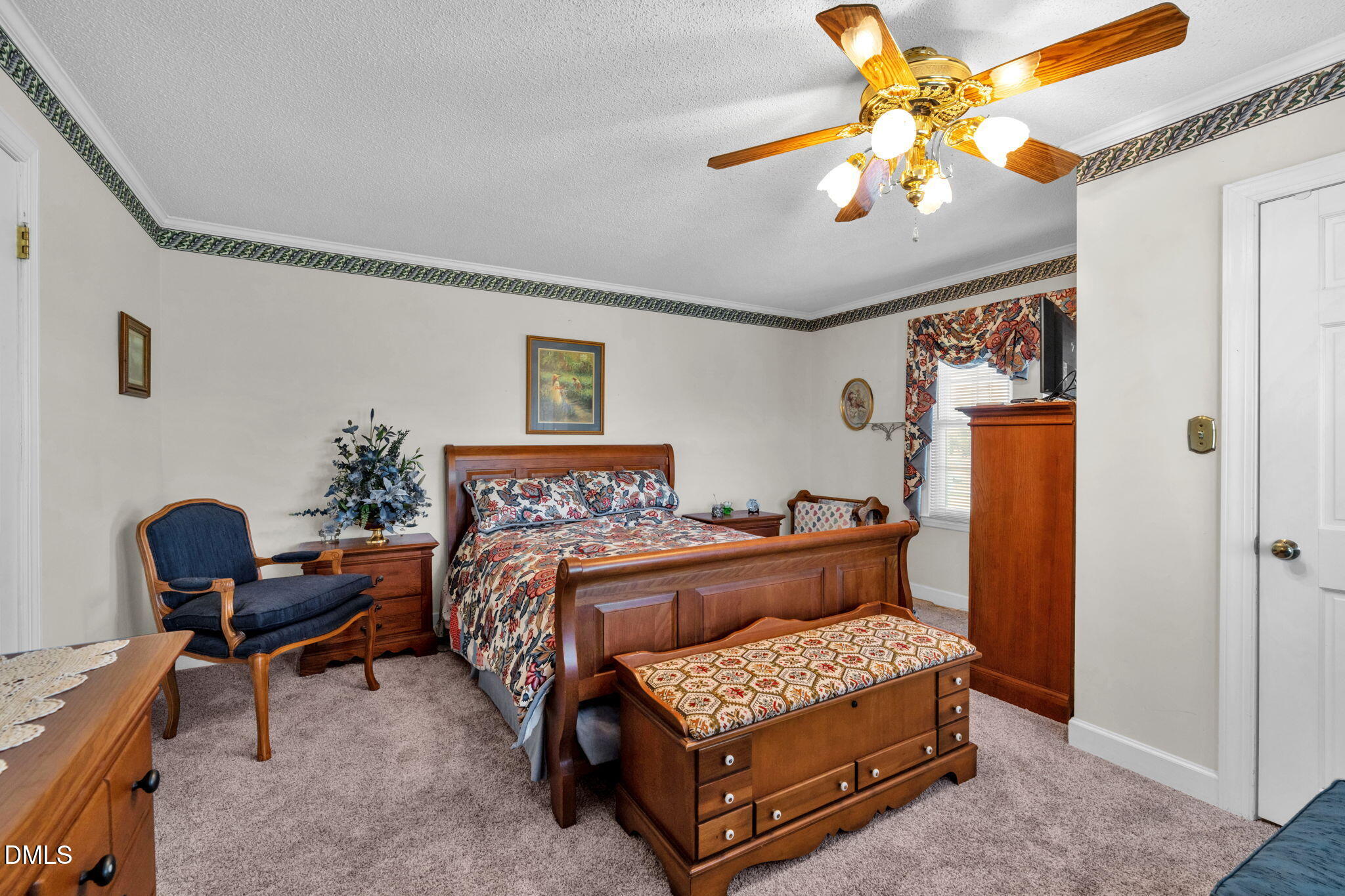 401 Allens Crossroads Road Four Oaks, NC 27524 - Photo 23 of 64 a bedroom with a bed and a chandelier