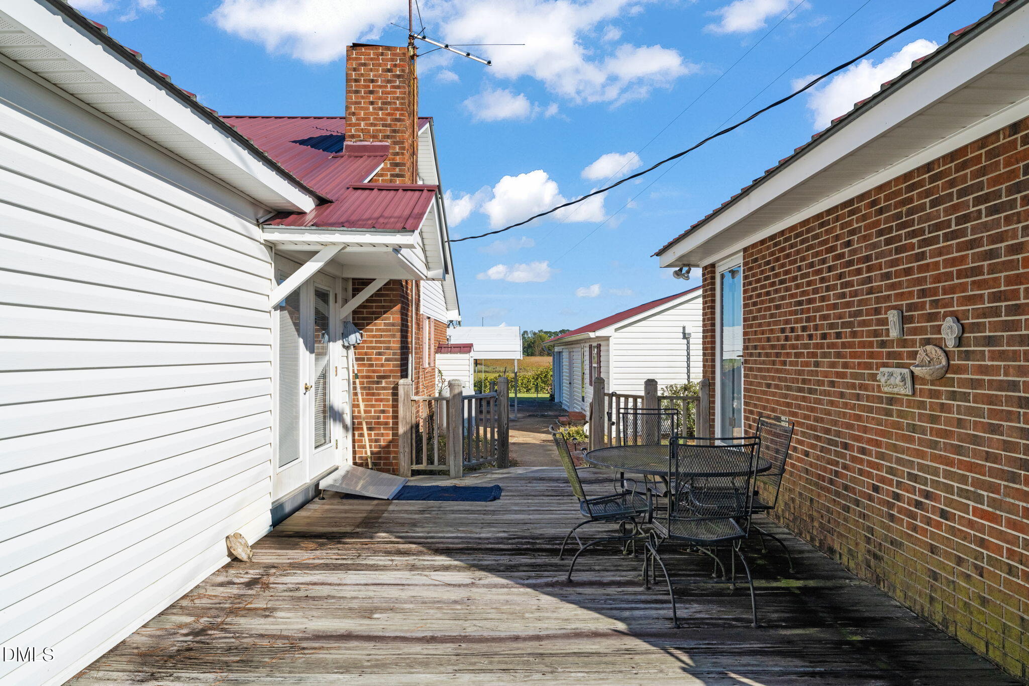401 Allens Crossroads Road Four Oaks, NC 27524 - Photo 34 of 64 a view of a patio with table and chairs with wooden floor and fence