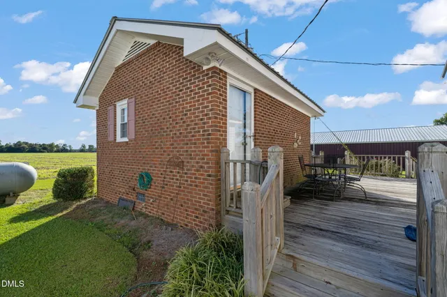 a view of a house with a yard and sitting area