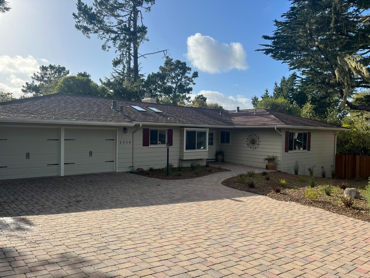 a front view of a house with a yard and parking space