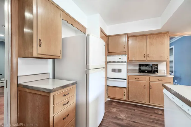 a kitchen with stainless steel appliances granite countertop a refrigerator sink and stove