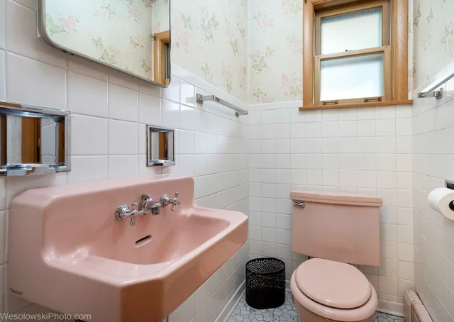 a bathroom with a sink a toilet and mirror
