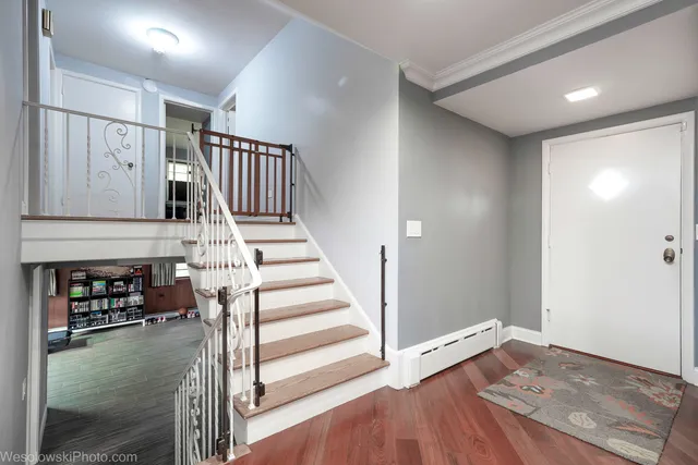 a view of an entryway with wooden floor