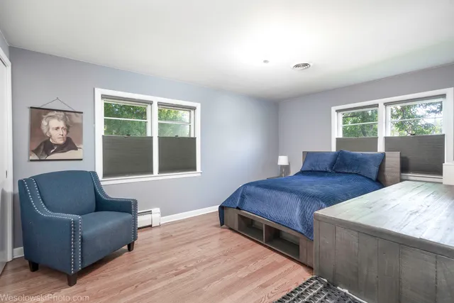 a bedroom with a bed couch and window