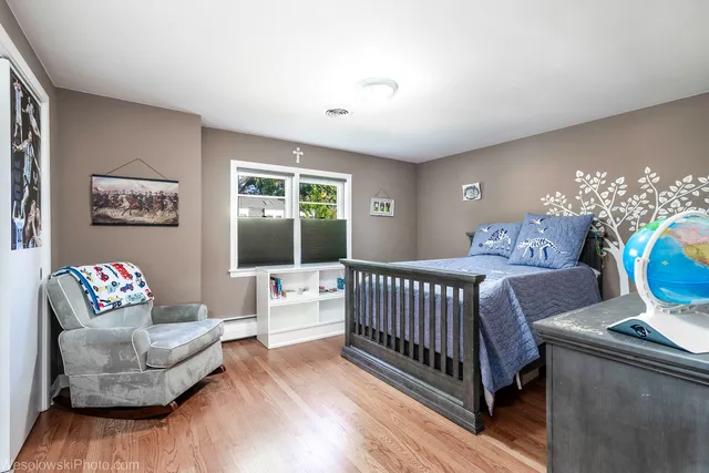 a bedroom with furniture and a large window