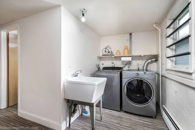 a utility room with sink dryer and washer