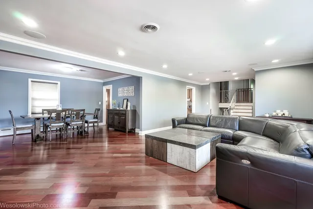 a living room with furniture and wooden floor