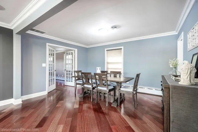 a view of a dining room with furniture and wooden floor