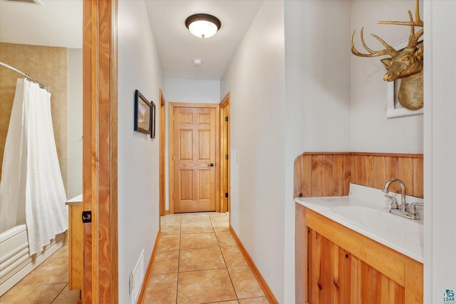 6266 Giants Ridge Road Biwabik, MN 55705 - Photo 27 of 37 Hallway featuring tile flooring and light wood doors