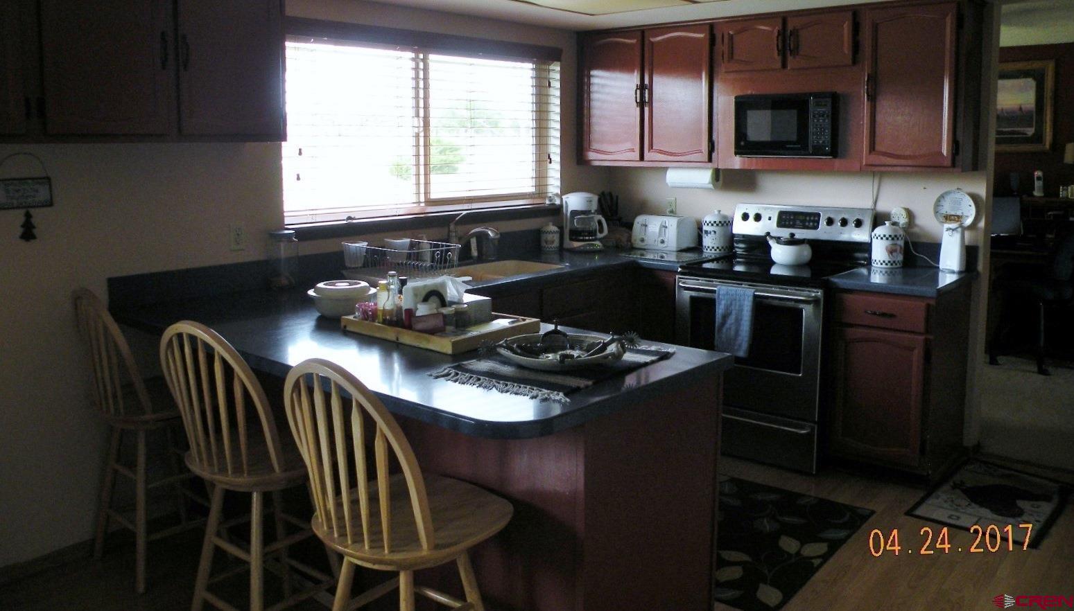 30146 DD31 Road Nucla, CO 81424 - Photo 16 of 25 a kitchen with a table chairs stove and microwave
