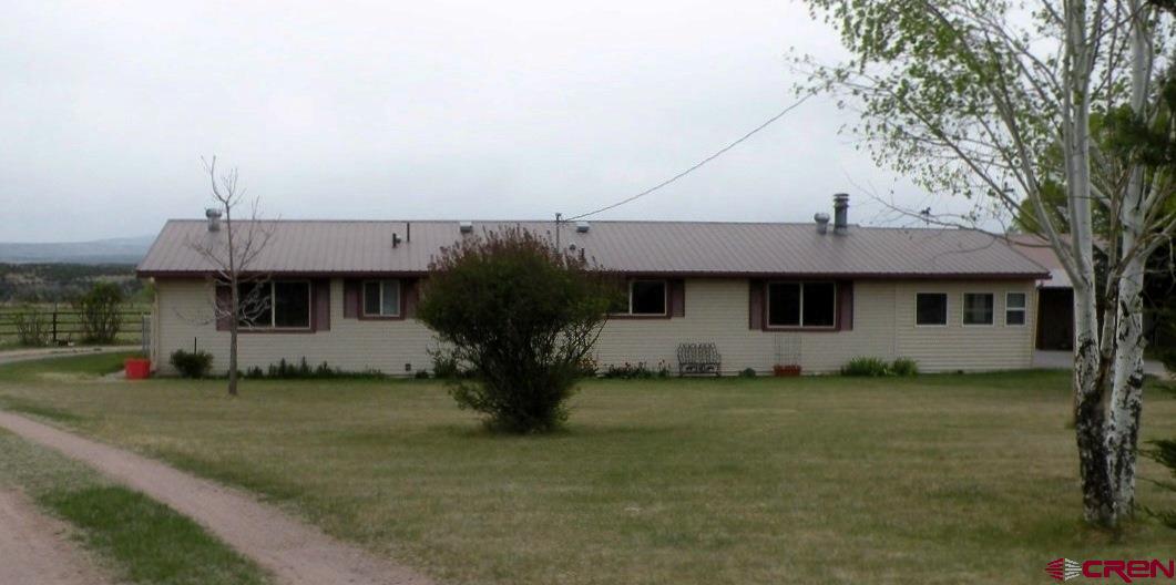 30146 DD31 Road Nucla, CO 81424 - Photo 2 of 25 a front view of a house with a garden and tree