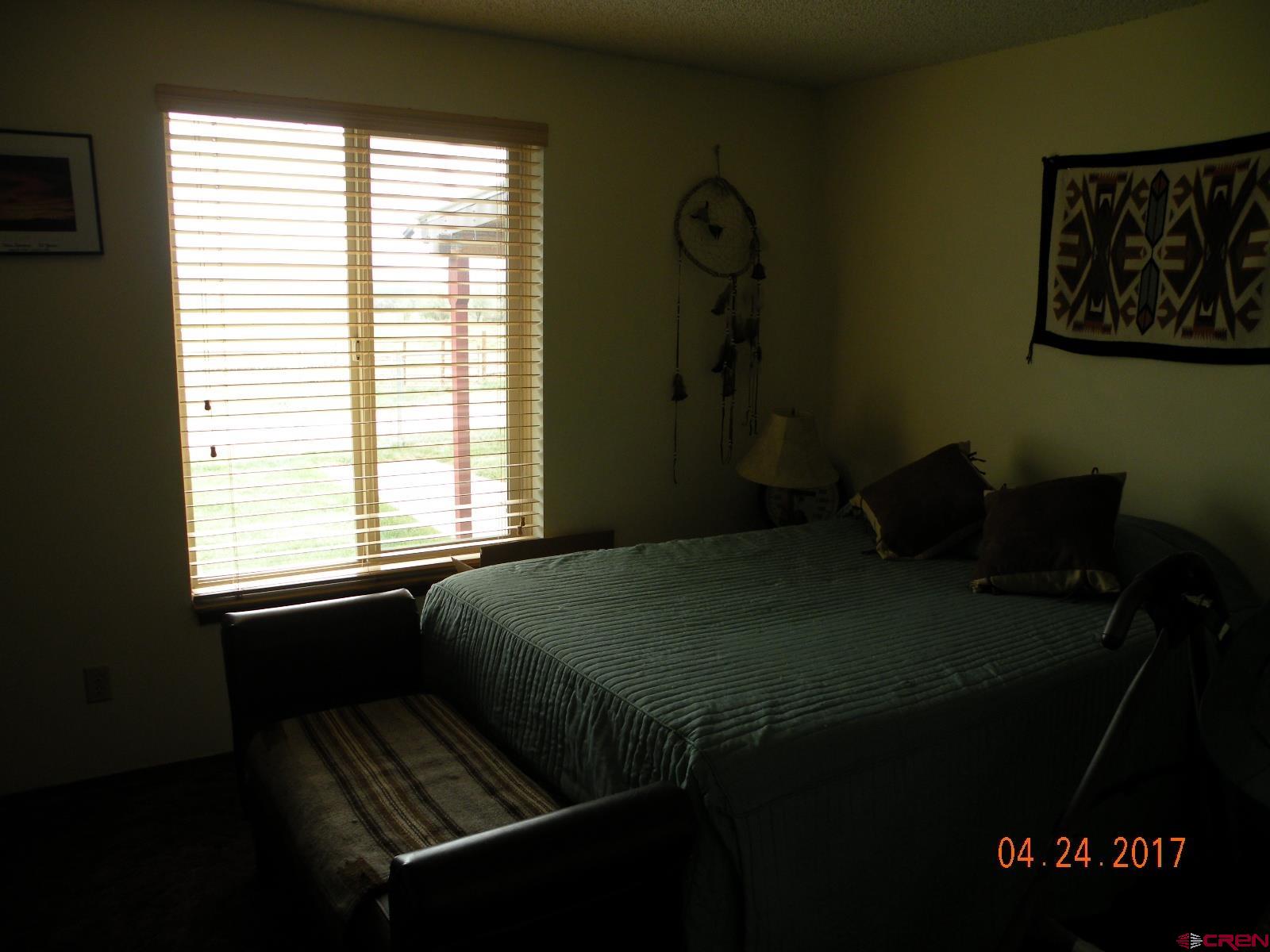 30146 DD31 Road Nucla, CO 81424 - Photo 22 of 25 a bed sitting in a bedroom next to a window