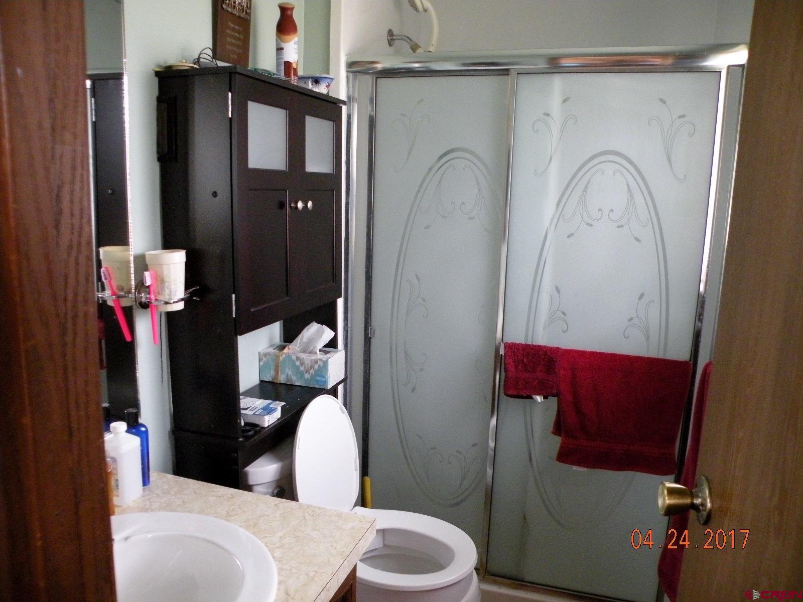 30146 DD31 Road Nucla, CO 81424 - Photo 24 of 25 a white toilet sitting next to a bathroom sink