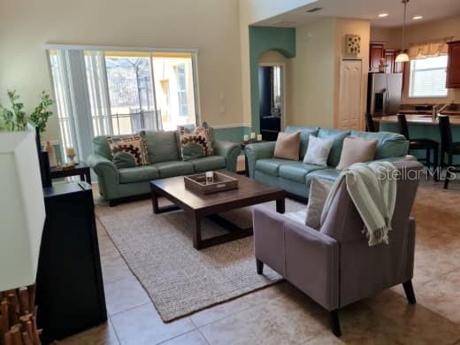 8923 Cuban Palm Road Kissimmee, FL 34747 - Photo 15 of 87 a living room with furniture and a large window