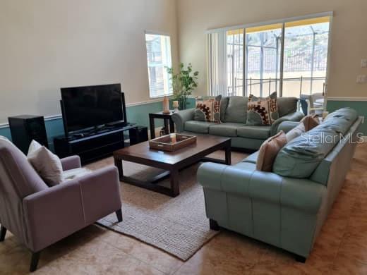 8923 Cuban Palm Road Kissimmee, FL 34747 - Photo 16 of 87 a living room with furniture and a flat screen tv