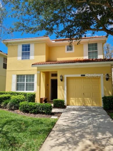 8923 Cuban Palm Road Kissimmee, FL 34747 - Photo 2 of 87 a front view of a house with garden