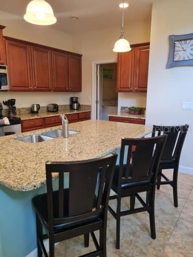 8923 Cuban Palm Road Kissimmee, FL 34747 - Photo 23 of 87 a kitchen with granite countertop a table chairs stove and microwave