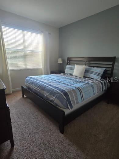 8923 Cuban Palm Road Kissimmee, FL 34747 - Photo 30 of 87 a bedroom with a bed lamp and window