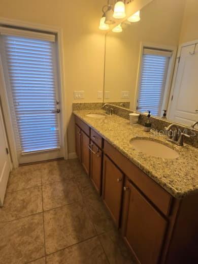 8923 Cuban Palm Road Kissimmee, FL 34747 - Photo 40 of 87 a bathroom with a granite countertop sink and a mirror