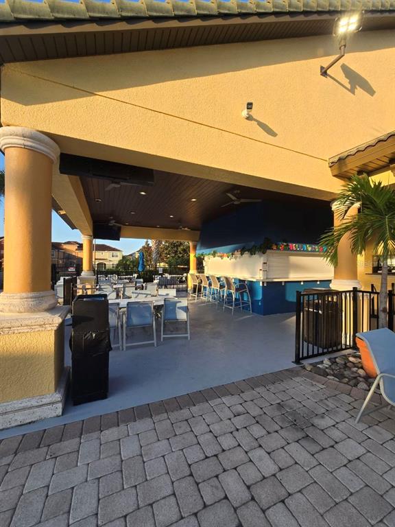 8923 Cuban Palm Road Kissimmee, FL 34747 - Photo 49 of 87 a view of a patio with dining table and chairs with wooden floor