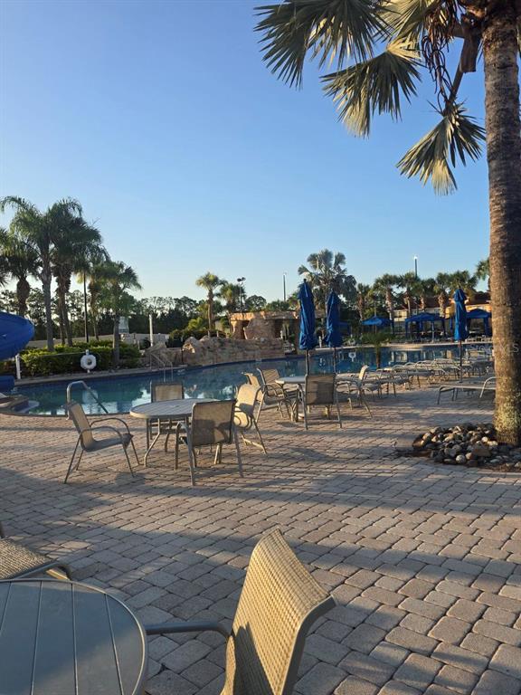8923 Cuban Palm Road Kissimmee, FL 34747 - Photo 76 of 87 a view of a swimming pool with a table and chairs