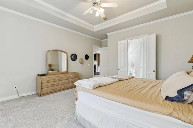 a bedroom with a bed and a dresser