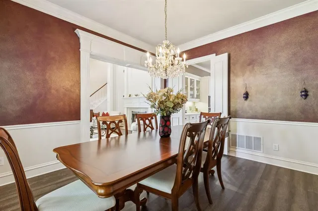 a dining room with furniture and chandelier