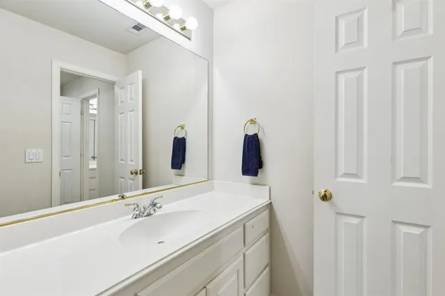 a bathroom with a double vanity sink and mirror