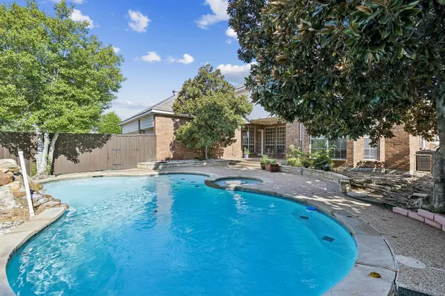 a swimming pool with outdoor seating and yard