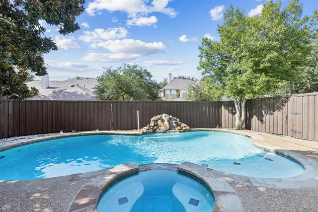 a view of a backyard with wooden fence