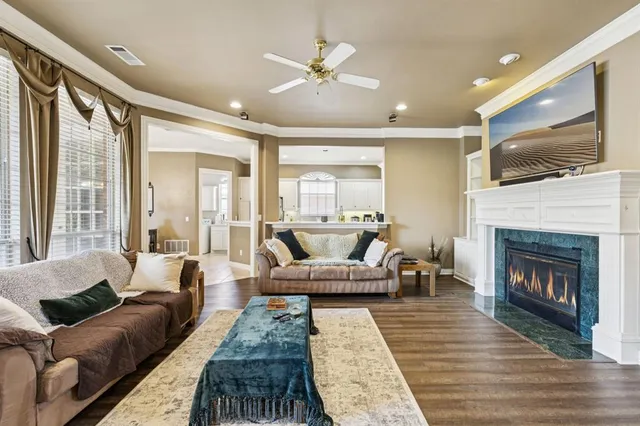 a living room with furniture fireplace and flat screen tv