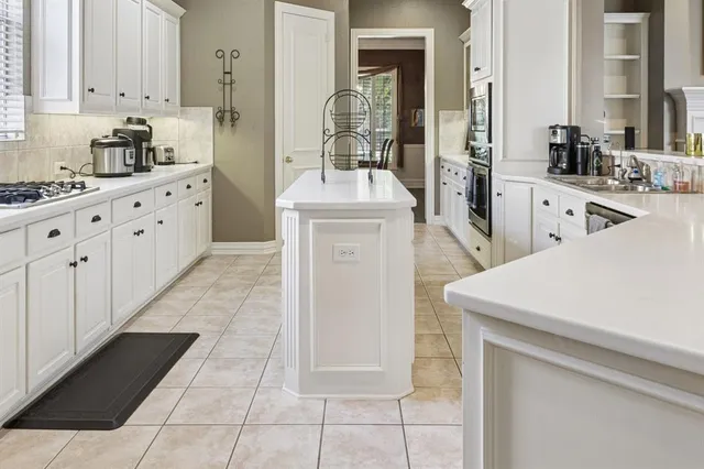 a kitchen with stainless steel appliances a sink stove and cabinets