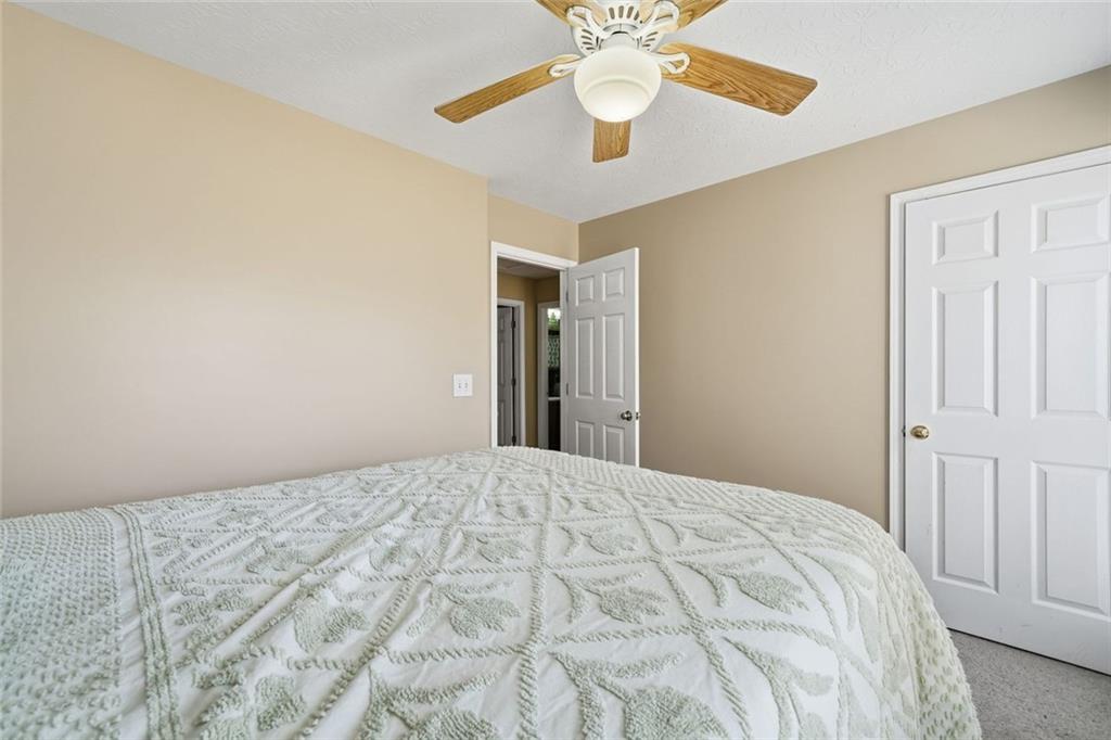 137 Orchard Way Southeast Calhoun, GA 30701 - Photo 19 of 37 a bedroom with a bed and a chandelier