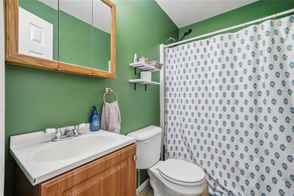137 Orchard Way Southeast Calhoun, GA 30701 - Photo 22 of 37 a bathroom with a sink a toilet and a mirror