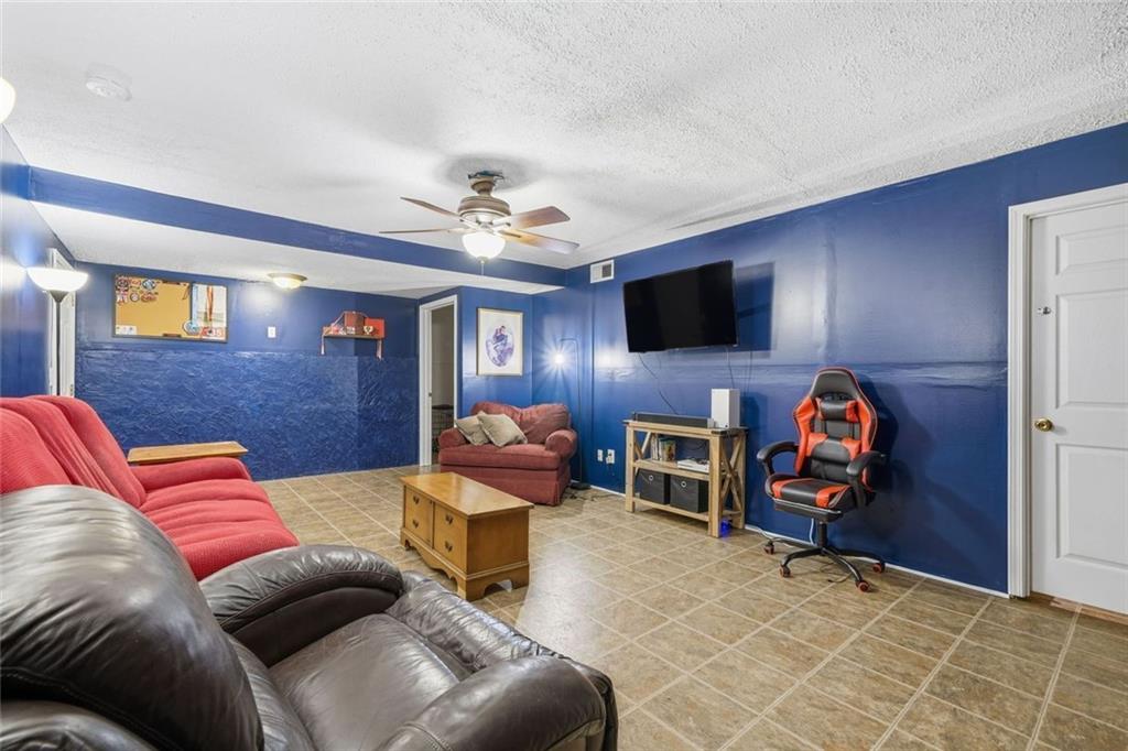 137 Orchard Way Southeast Calhoun, GA 30701 - Photo 23 of 37 a living room with furniture and a flat screen tv