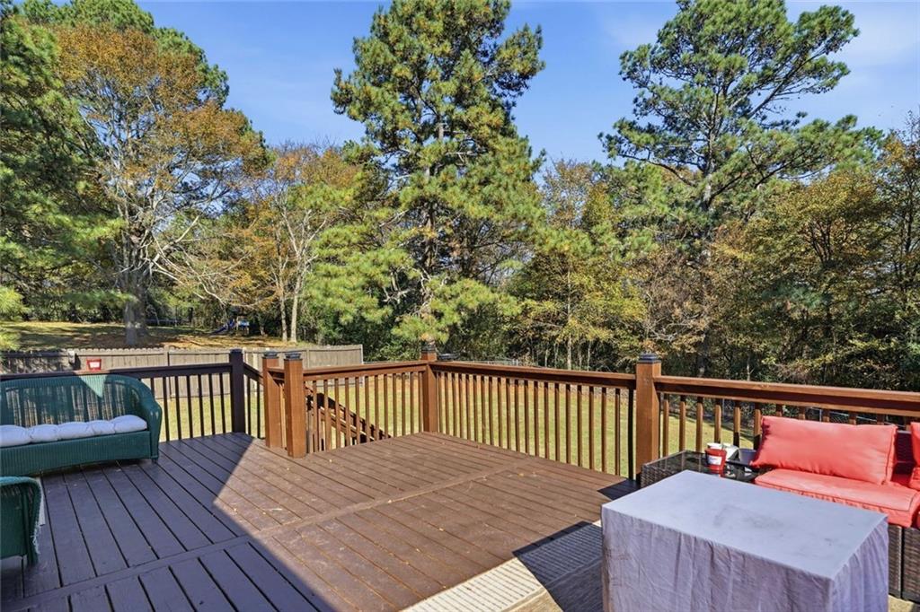 137 Orchard Way Southeast Calhoun, GA 30701 - Photo 28 of 37 a view of a wooden deck with a bench
