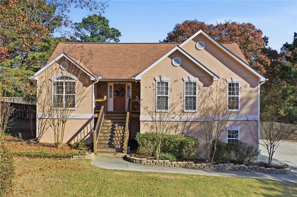137 Orchard Way Southeast Calhoun, GA 30701 - Photo 29 of 37 a view of a white house next to a yard with plants and large trees
