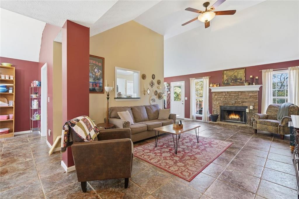 137 Orchard Way Southeast Calhoun, GA 30701 - Photo 5 of 37 a living room with furniture a fireplace and a floor to ceiling window