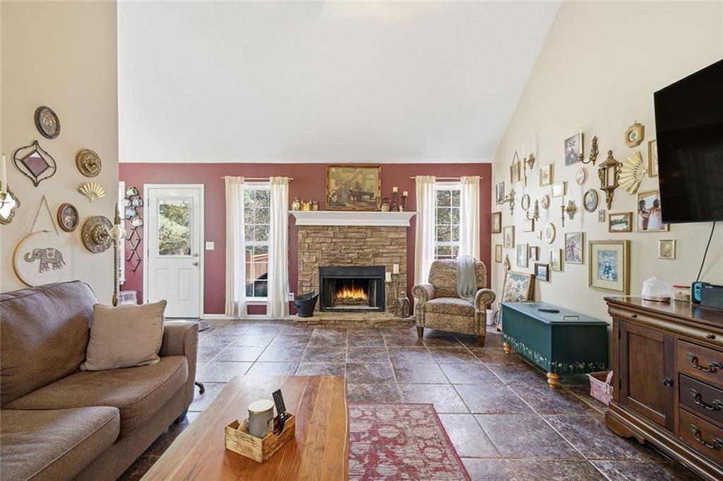137 Orchard Way Southeast Calhoun, GA 30701 - Photo 6 of 37 a living room with furniture a flat screen tv and a fireplace