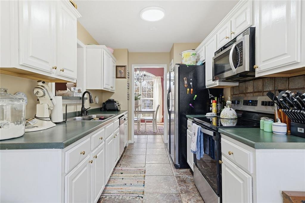 137 Orchard Way Southeast Calhoun, GA 30701 - Photo 10 of 37 a kitchen with stainless steel appliances granite countertop a sink stove and refrigerator